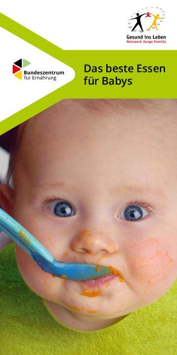 Ein Baby isst einen orangenen Brei
